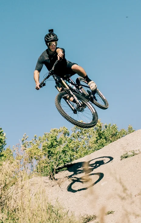 Jason Connor jumping a dusty trail
