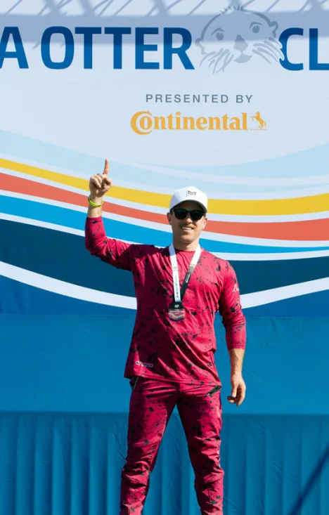 Celebrating on the podium in a race suit