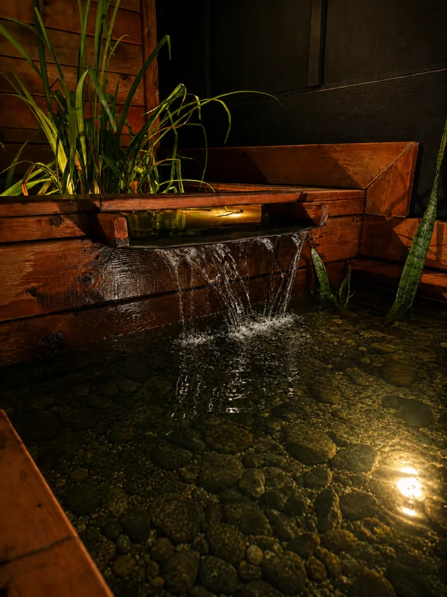 The water feature spilling into the pond