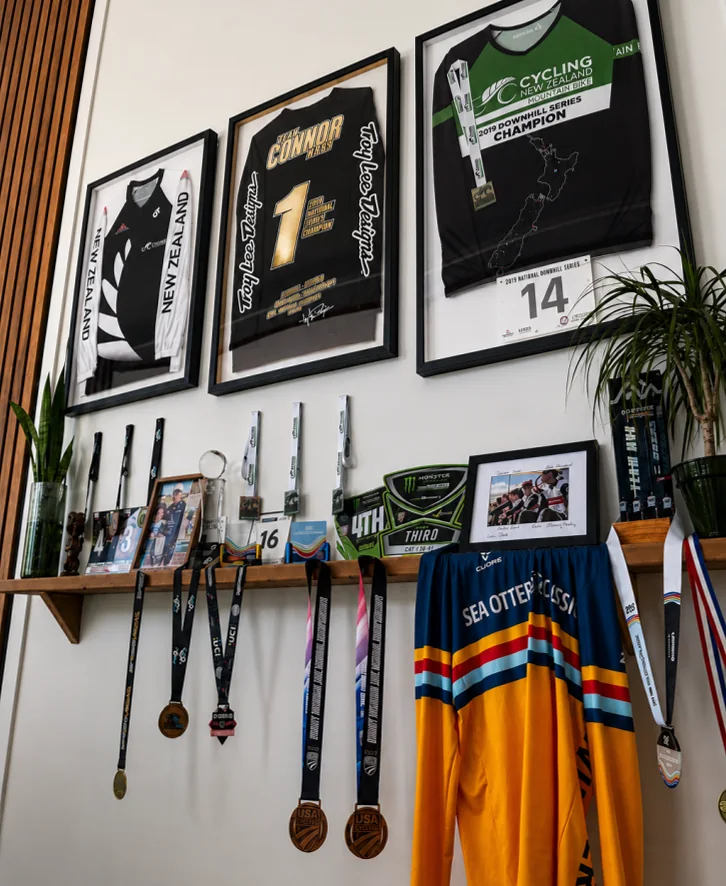 The trophy wall of race jerseys, plates and medals