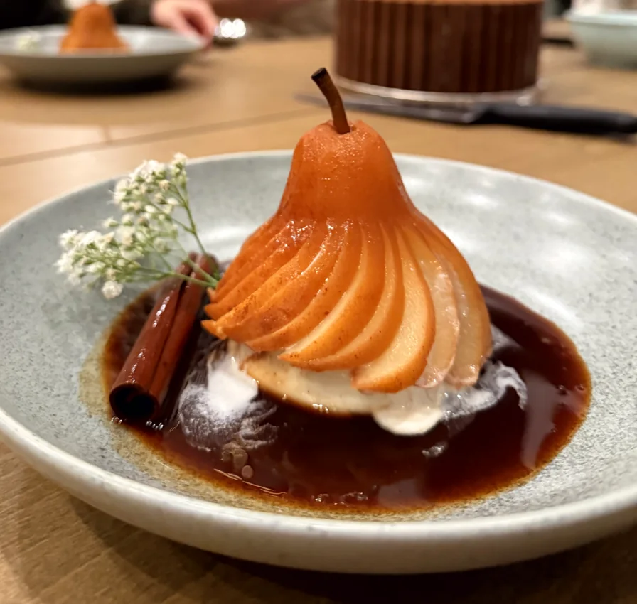 Poached spiced pear on Italian panna cotta