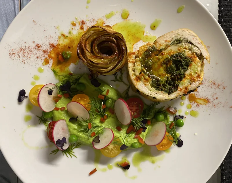 Braised chicken and spinach roll on pureed peas