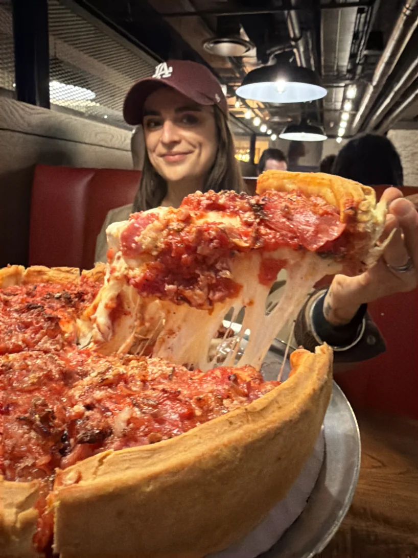 A slice lifted from a Chicago deep dish pizza