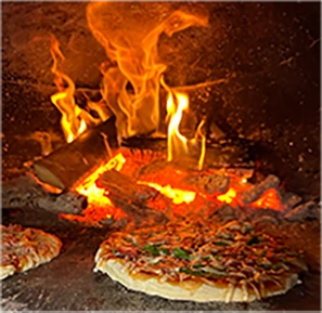 A pizza in a wood fired oven at home