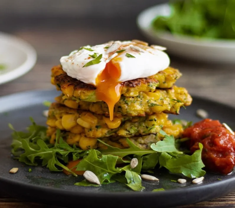 Corn fritters topped with a soft poached egg